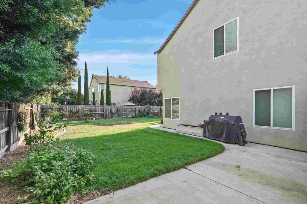 A house with a green lawn and a fence.