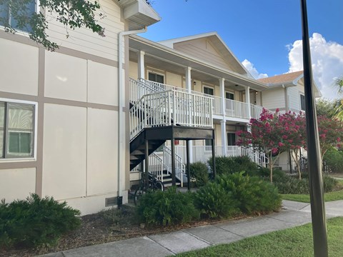 A building with a balcony and a staircase.