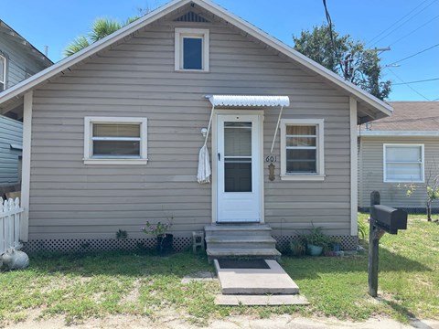 A small house with a white door and windows.