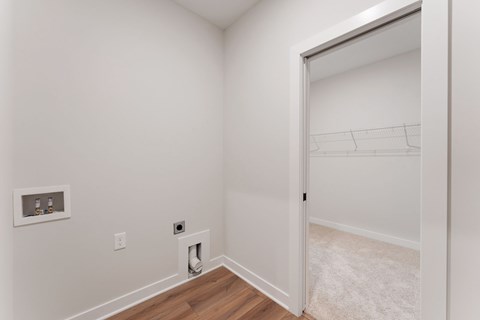 A white room with a doorway leading to another room.