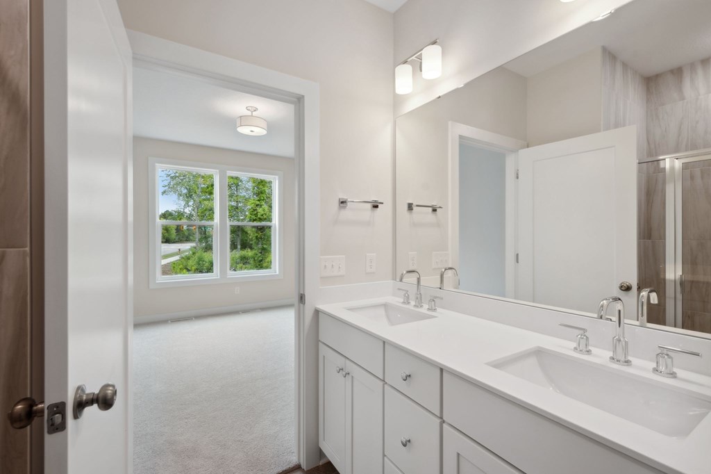 A bathroom with a white sink and a mirror.