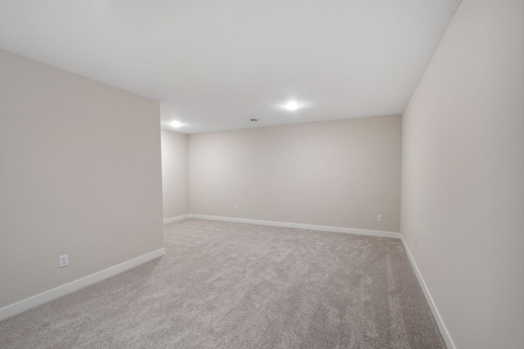 A room with carpeted floor and white walls.