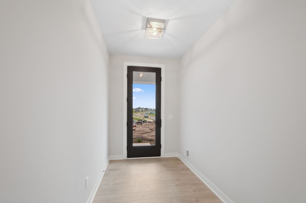 A room with a view of a parking lot through a window.