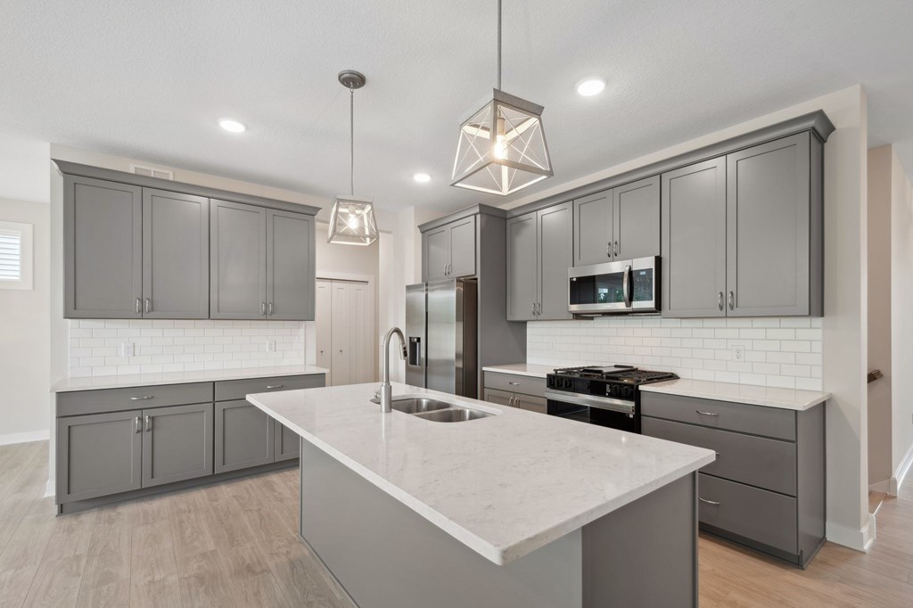 A modern kitchen with a large island in the center.