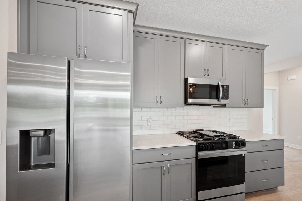 A modern kitchen with stainless steel appliances and cabinets.