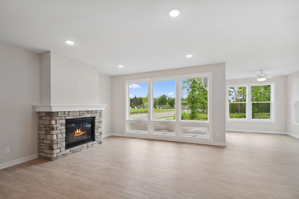 A spacious living room with a fireplace and sliding glass doors.