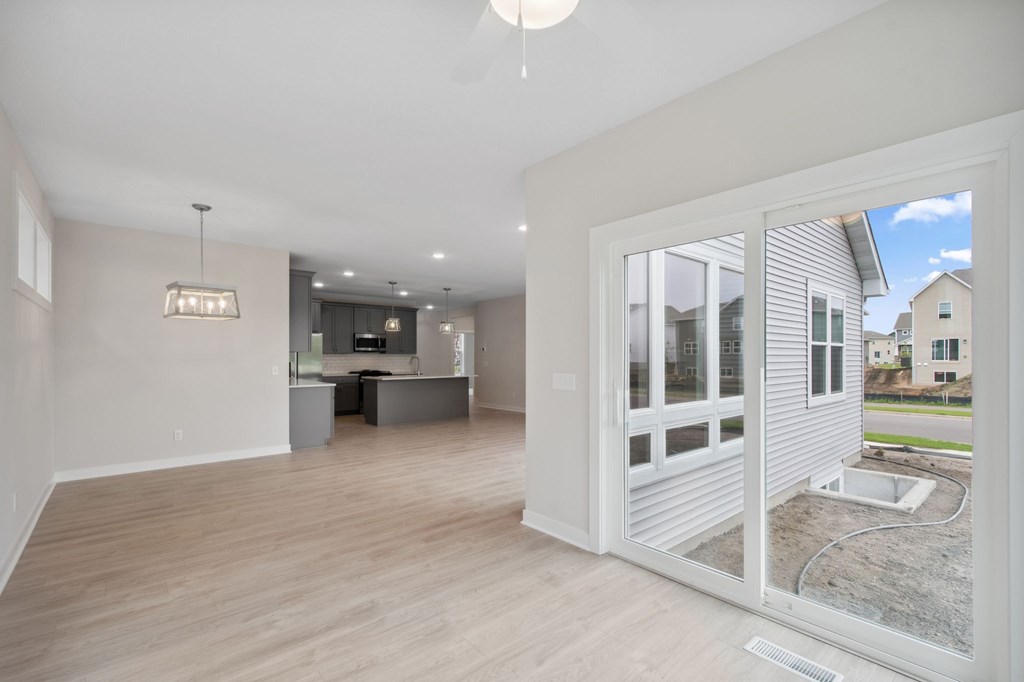 A modern living room with a sliding glass door leading to a construction site.