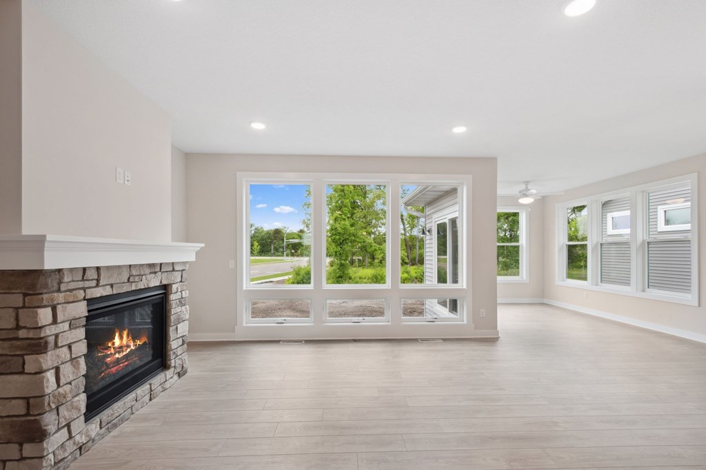 A modern living room with a fireplace and sliding glass doors.