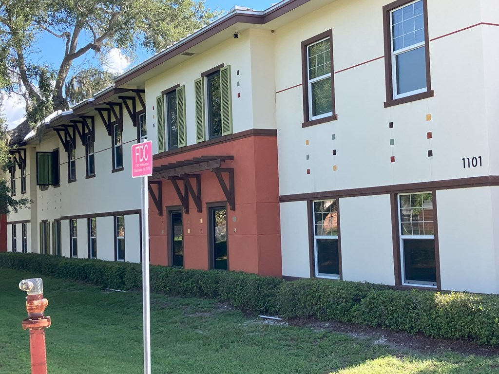 A white building with a red trim and a sign that says NW.