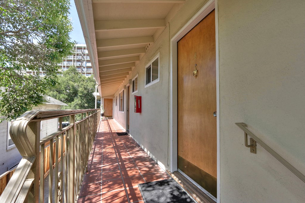 a long porch with a door to a balcony