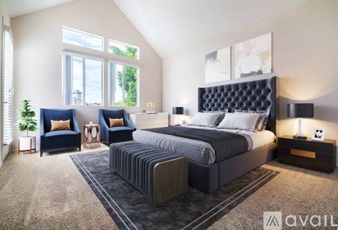 A bedroom with a large bed and a window with blinds.