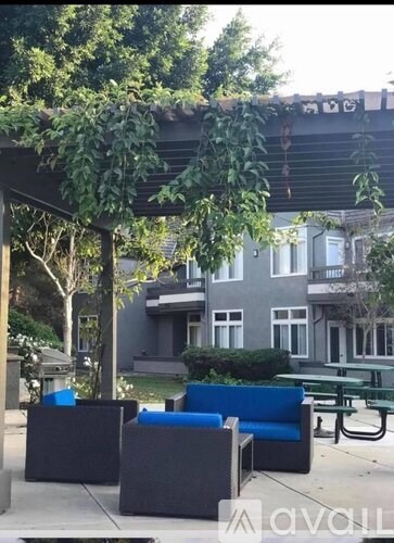A park with benches and trees.