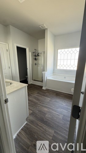 A bathroom with a tub and a walk-in shower.