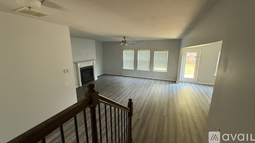 A room with a wooden floor and a ceiling fan.
