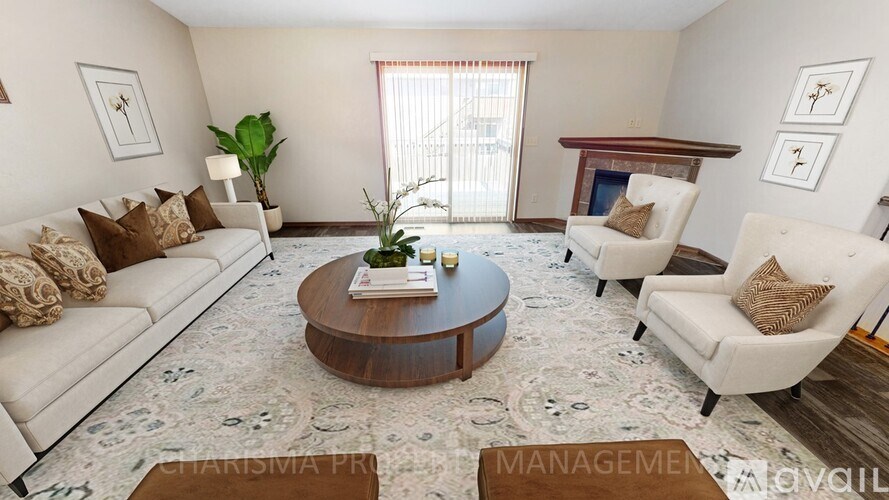 A living room with a white sofa, two white armchairs, a coffee table, and a rug.