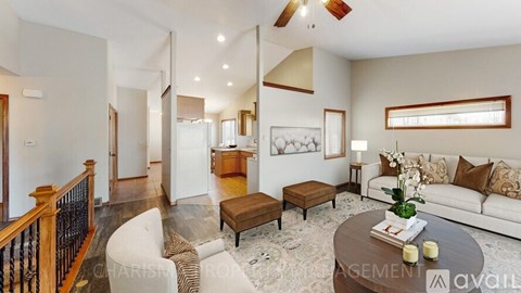 A living room with a white couch and a coffee table.