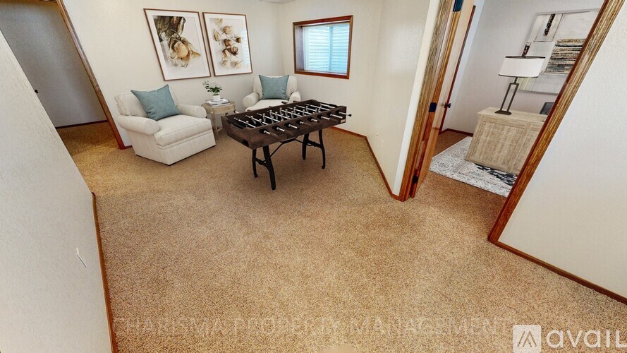 A living room with a couch, coffee table, and two framed pictures on the wall.