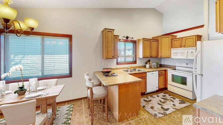 A kitchen with wooden cabinets and a white fridge.