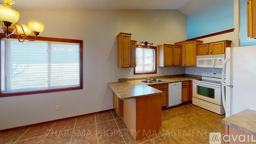 A kitchen with wooden cabinets and a white refrigerator.