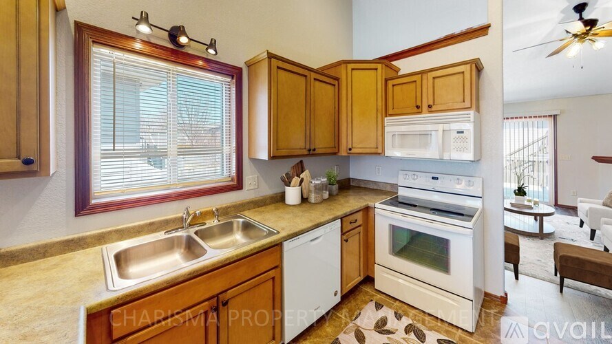 A kitchen with wooden cabinets and a white oven.
