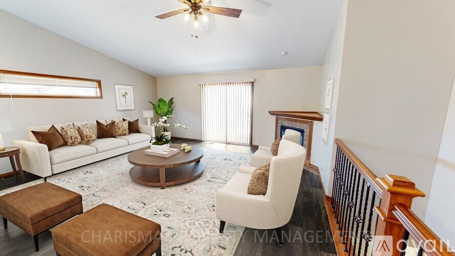 A living room with a white sofa, a wooden coffee table, and a white armchair.