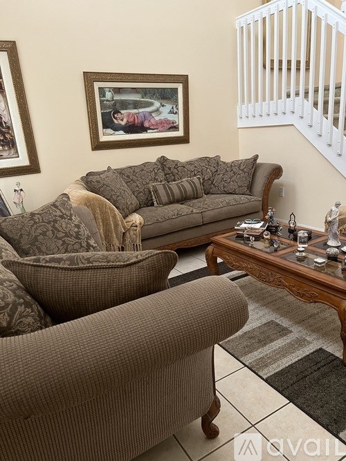 A living room with a brown couch and a coffee table.