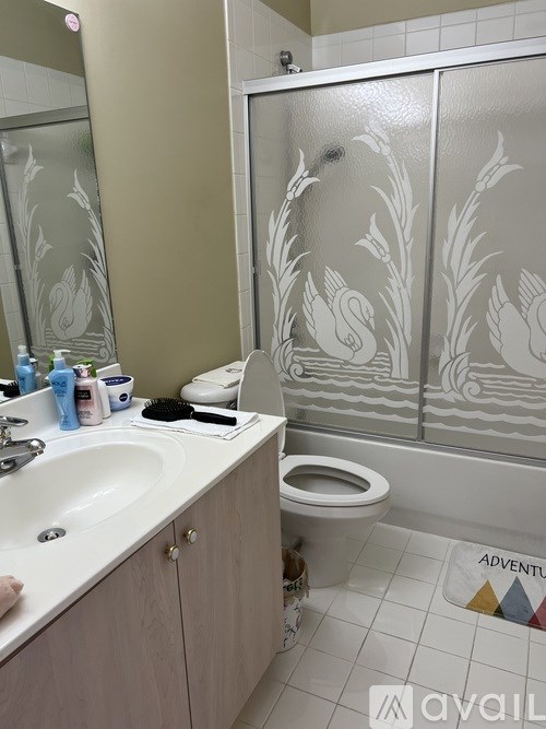 A bathroom with a white sink and a white toilet.