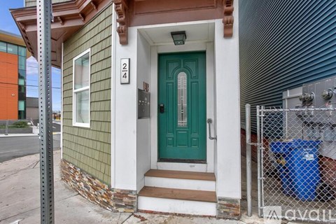 A house with a green door and number 24 on the wall.