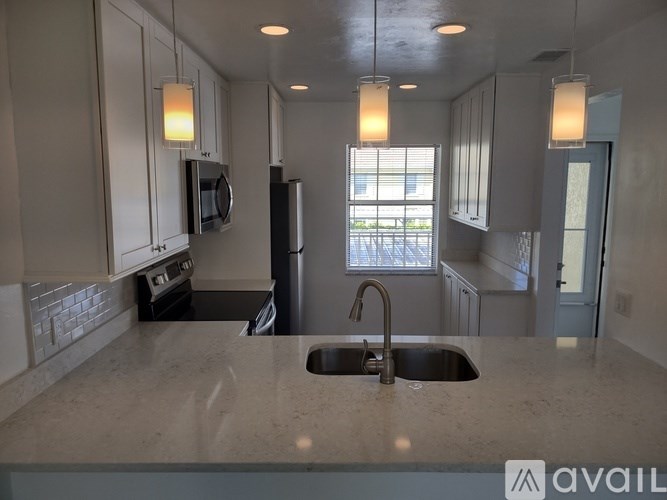 A kitchen with a sink and a window.