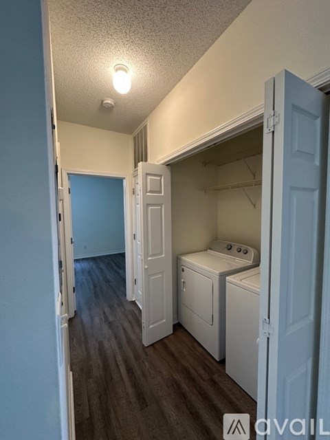 A small laundry room with a washer and dryer.