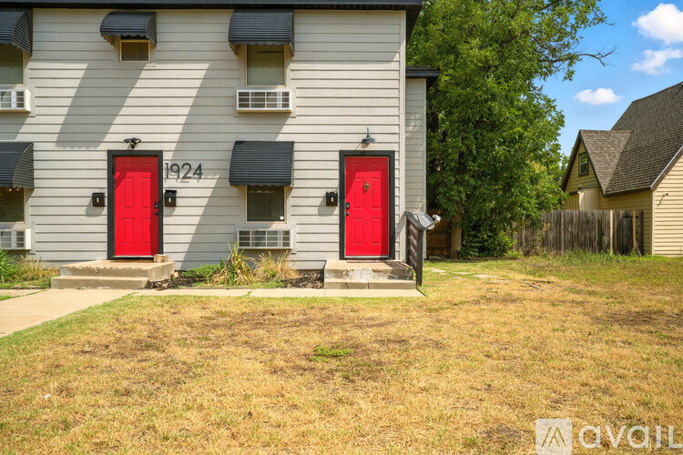 A building with the number 1924 on it has two red doors.