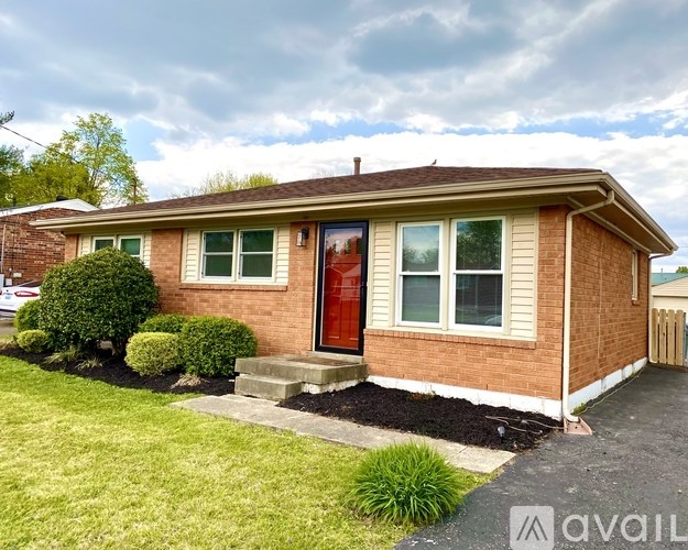 A house with a red door and a brown roof.