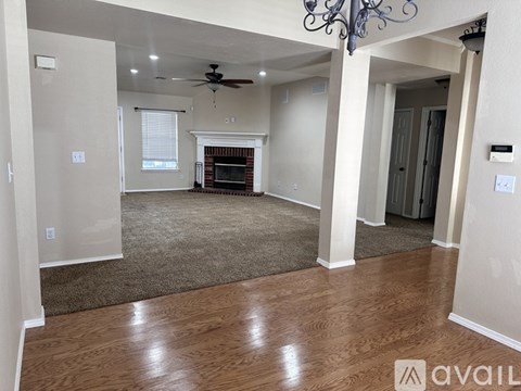 A living room with a fireplace and a chandelier.