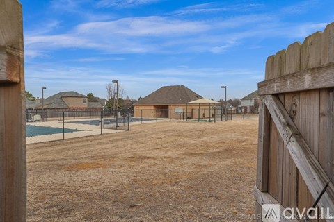A spacious room with a ceiling fan and carpeted floor.