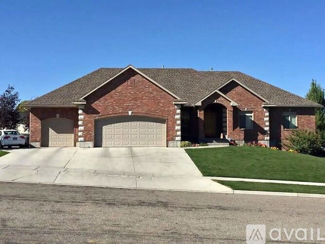 A brick house with a garage door and a driveway.