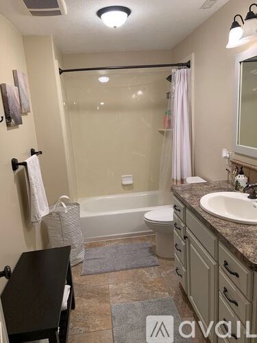 A bathroom with a toilet, sink, and bathtub.