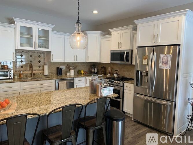 A kitchen with granite countertops and stainless steel appliances.