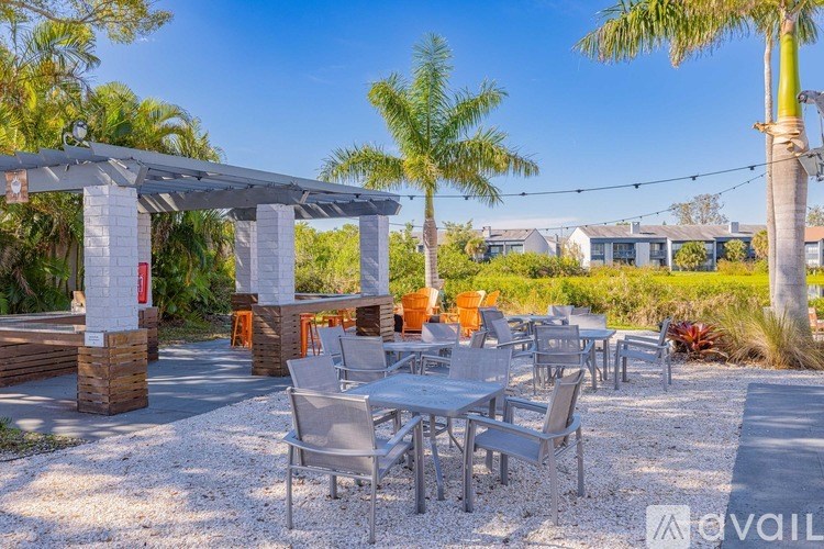 A patio with a table and chairs under a pergola.