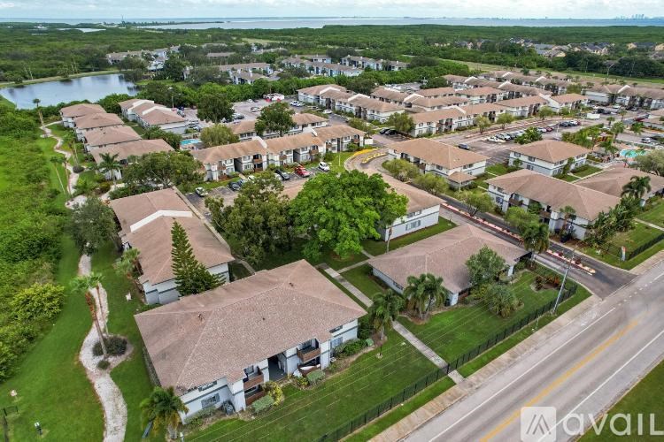 A bird's eye view of a residential area with houses and a road.