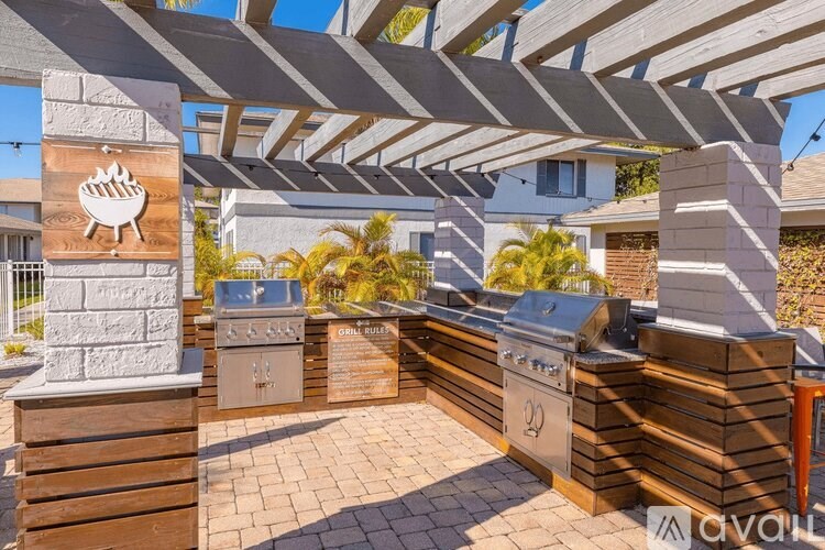 A patio with a grill and a barbecue sign.