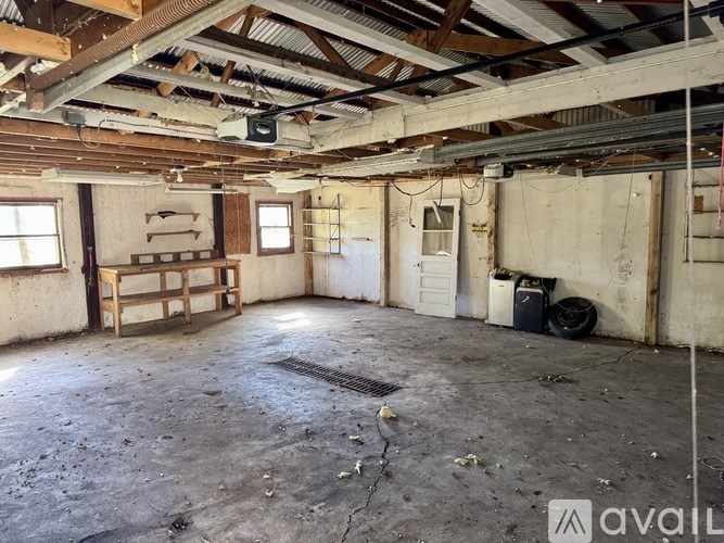 A large, empty room with a high ceiling and exposed beams.