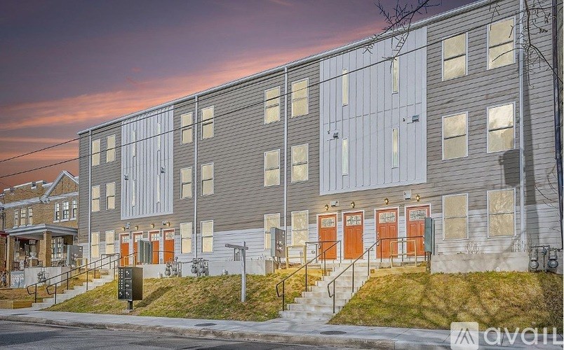 A building with grey walls and orange doors is shown in the image.