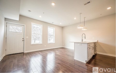A kitchen area with a white cabinet and a window.