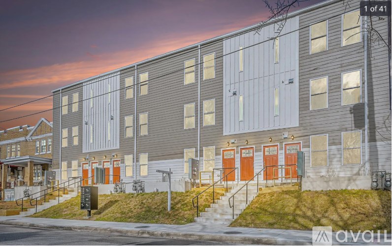 A building with grey and orange doors is shown in the image.