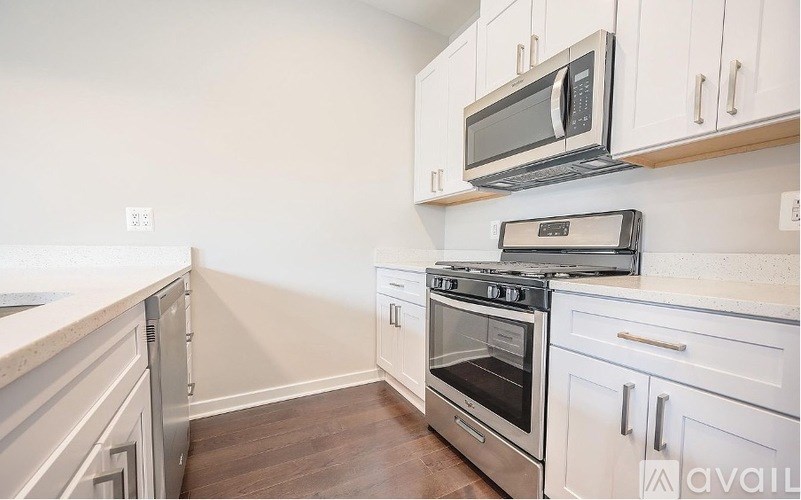 A kitchen with a stove, oven, and microwave.