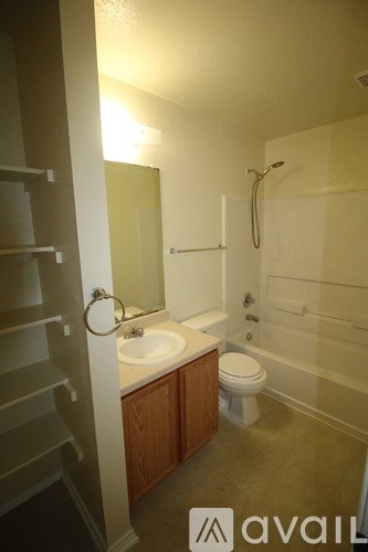 A bathroom with a sink, toilet and shower.