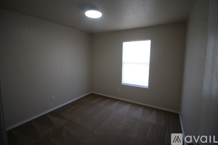 A room with a window and a light on the ceiling.