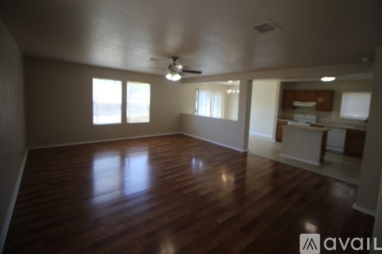 A room with wooden floors and a ceiling fan.