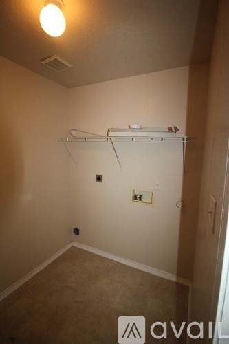 A room with a white wall and a white shelf.