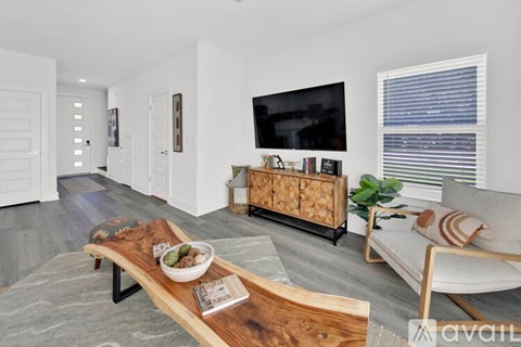 A modern living room with a wooden coffee table and a white sofa.